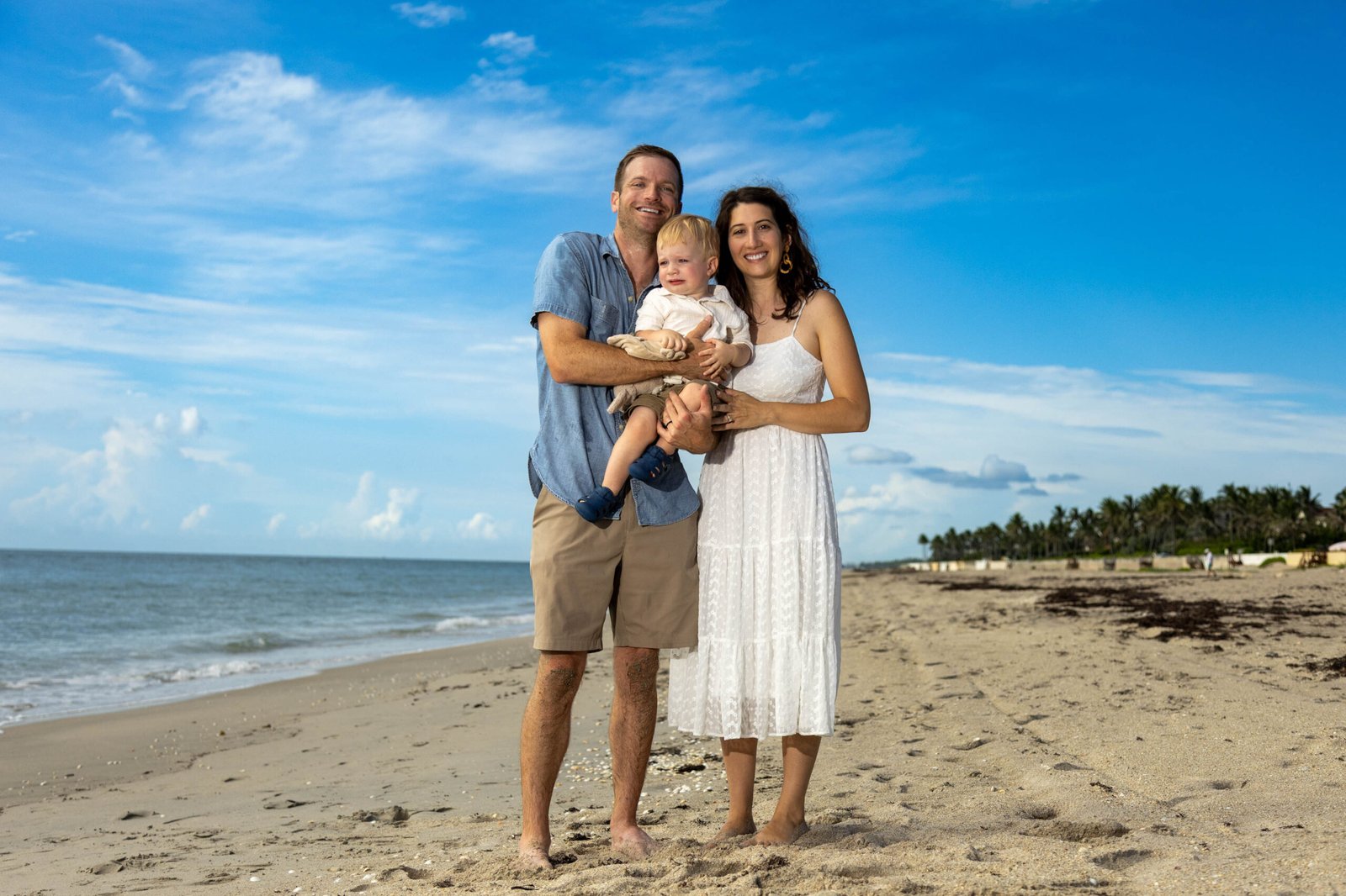 Parents holding their baby on a Florida beach during a family photo session