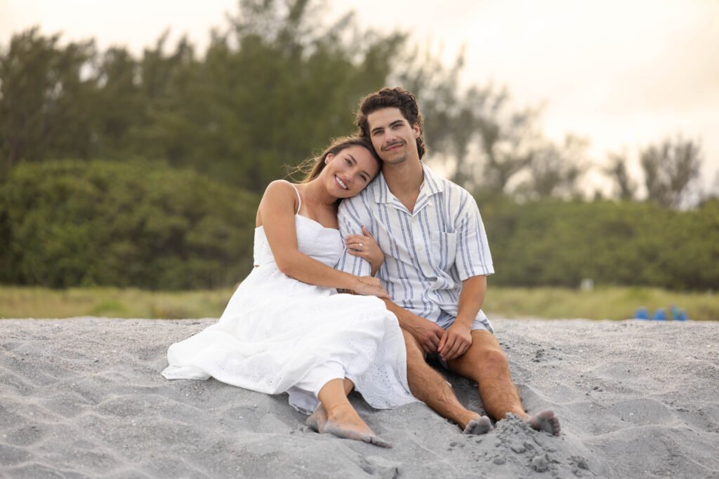 Couple sitting together outdoor engagement session West Palm Beach engagement photographer