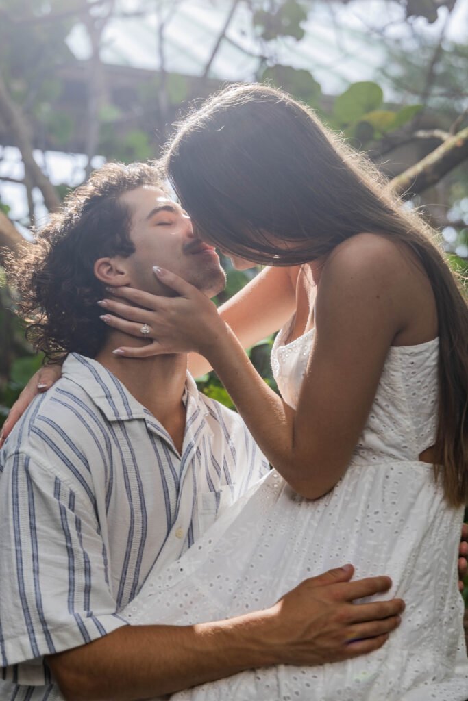 Couple kissing golden hour sunlight West Palm Beach engagement photographer romantic backlit