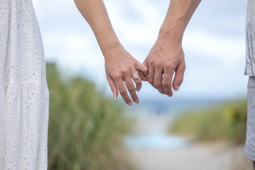 Close up engaged couple holding hands showing rings West Palm Beach engagement photographer romantic detail