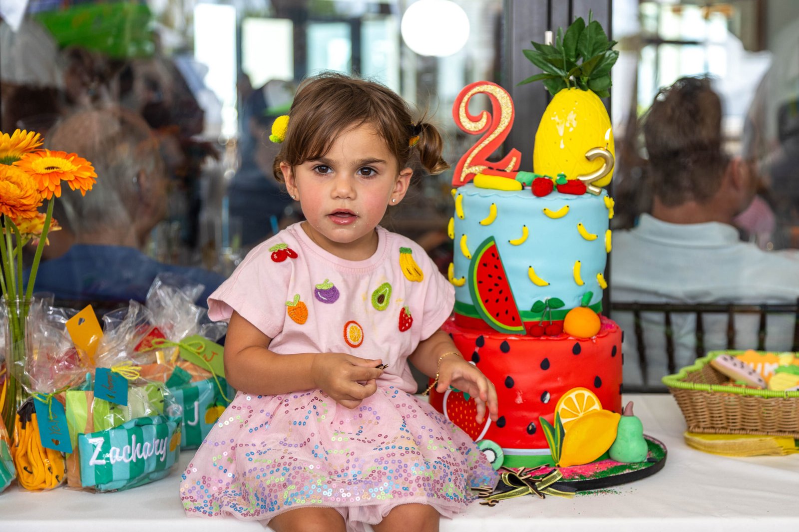 Toddler with her second birthday cake during a West Palm Beach children's session