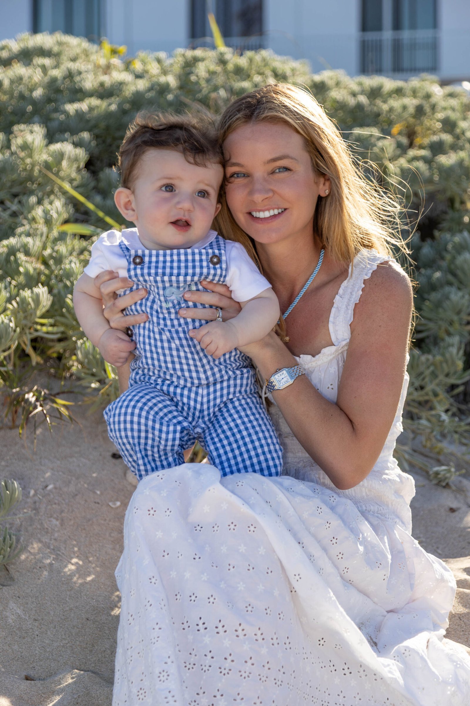 Mother holding her baby boy by the ocean at golden hour during a West Palm Beach session