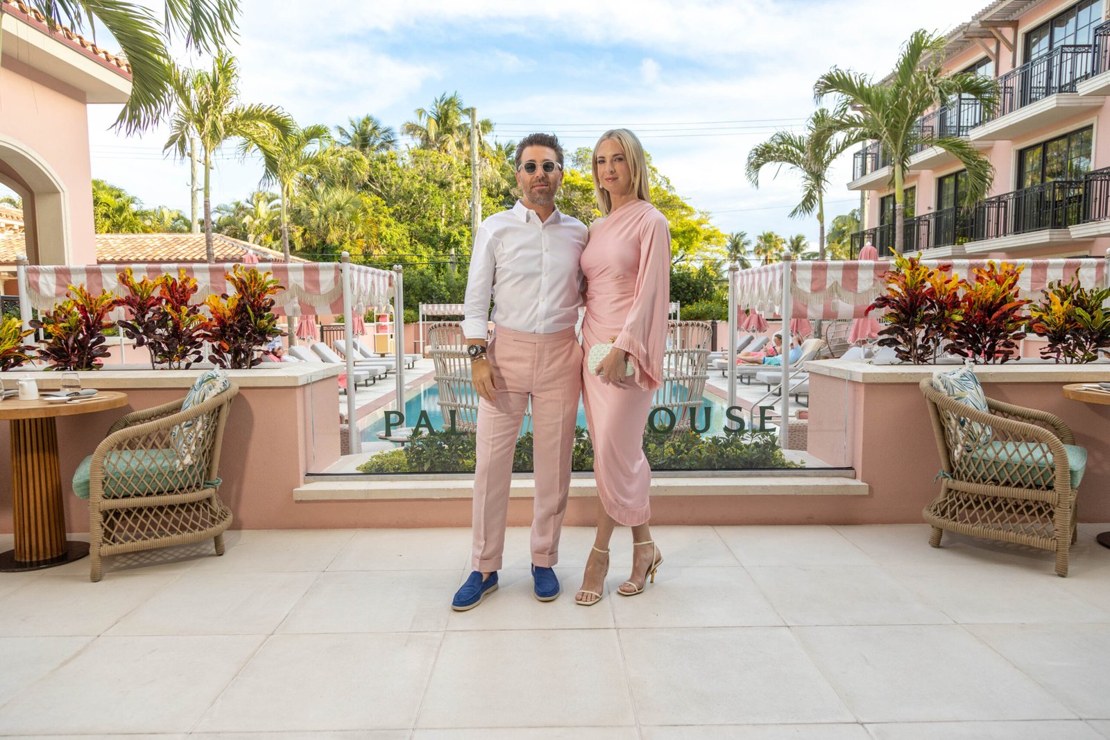Couple on a pink Palm Beach hotel terrace at an elegant event