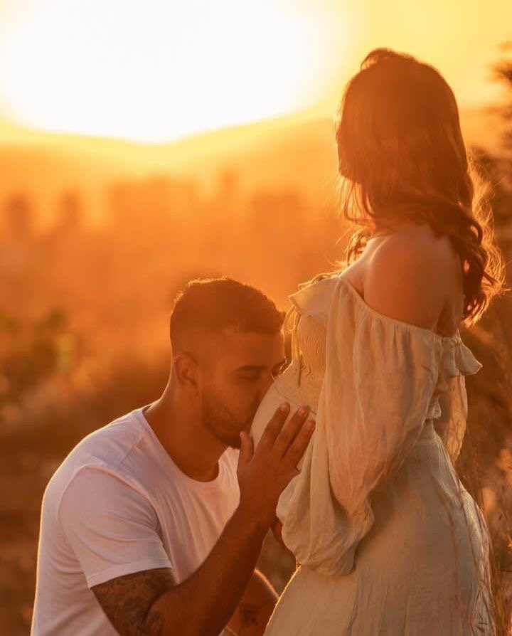 Backlit maternity silhouette at golden hour