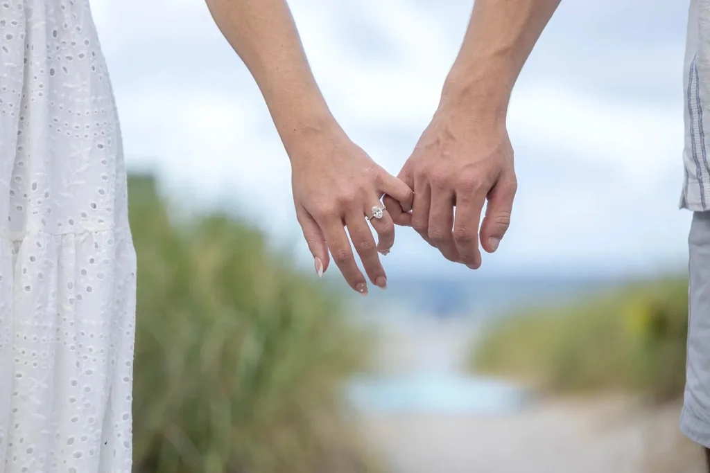 Close up engaged couple holding hands showing rings West Palm Beach engagement photographer romantic detail
