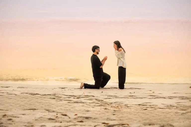 Beach proposal man kneeling proposing to woman West Palm Beach engagement photographer romantic moment