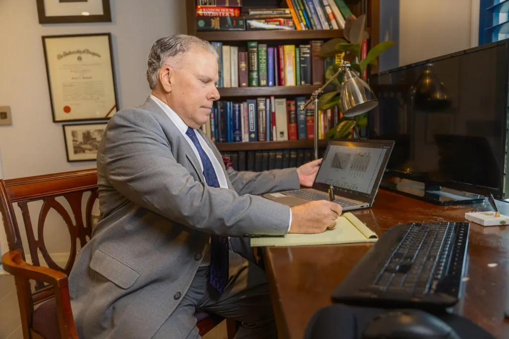 Attorney headshot at his desk in a West Palm Beach law office