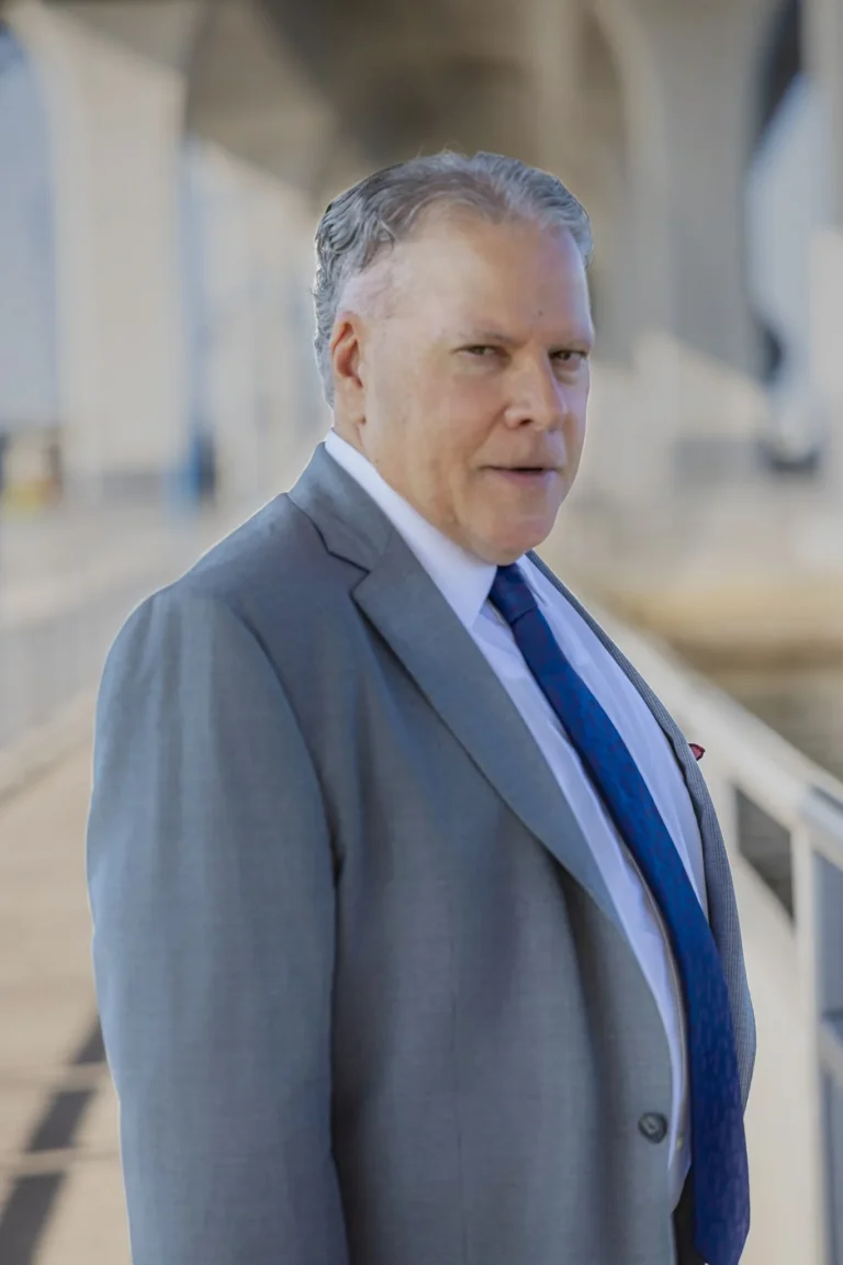 Outdoor attorney headshot under a bridge in Palm Beach, Florida