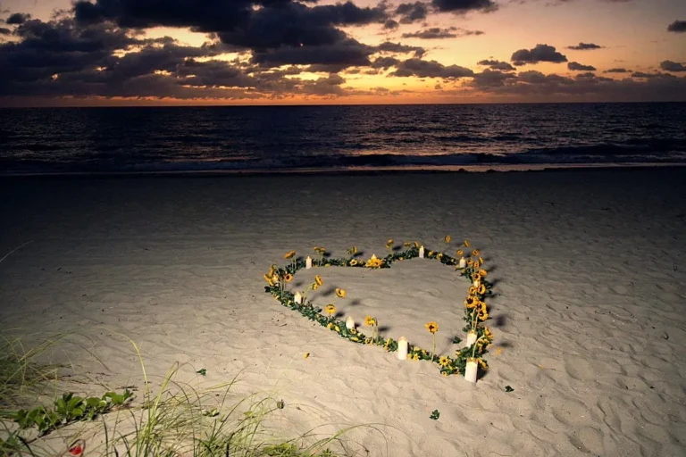 Sunrise marriage proposal setup with a heart of sunflowers and candles on the sand at Las Olas Beach in Fort Lauderdale, designed by The Love Pics for couples near West Palm Beach.