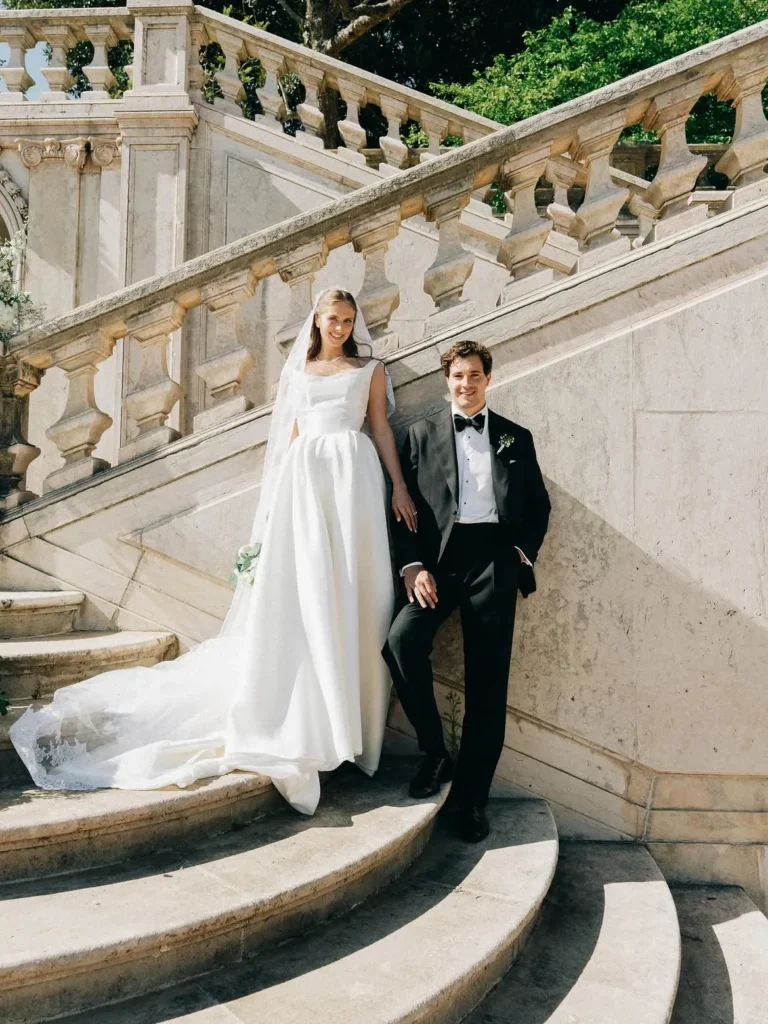 Bride and groom posing on a stone staircase, wedding photography in Palm Beach
